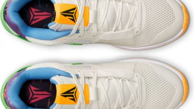 Detailed look at Ja Morant's white and yellow Nike shoes.